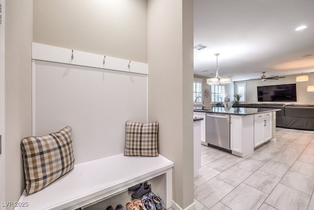 mudroom featuring ceiling fan and sink