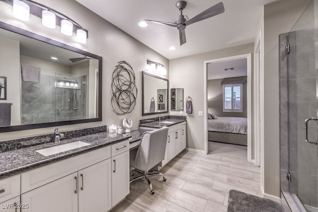 bathroom with vanity, an enclosed shower, and ceiling fan