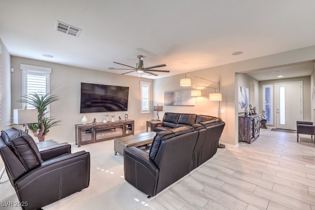 living room featuring light wood-type flooring and ceiling fan