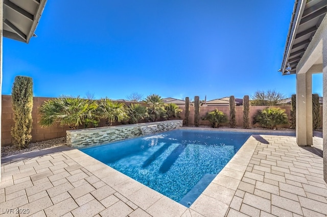 view of pool featuring pool water feature and a patio