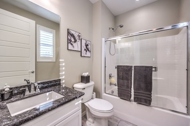 full bathroom with vanity, toilet, and shower / bath combination with glass door