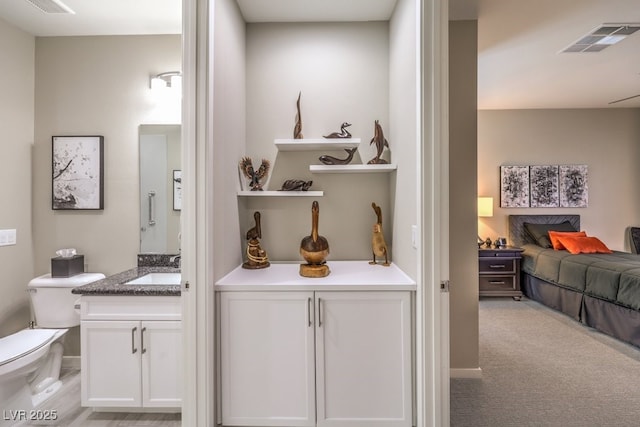 bathroom featuring vanity and toilet