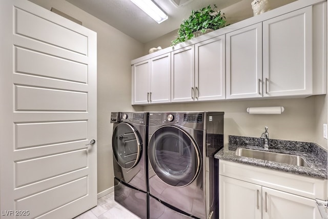 laundry area with separate washer and dryer, sink, and cabinets