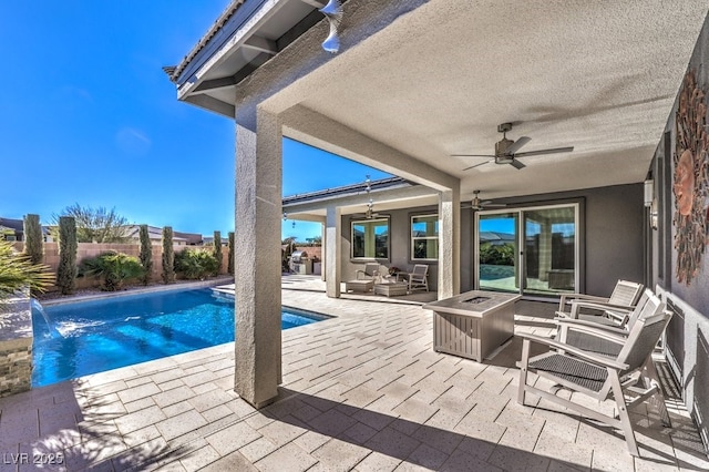 view of pool with pool water feature, ceiling fan, a patio area, and an outdoor hangout area