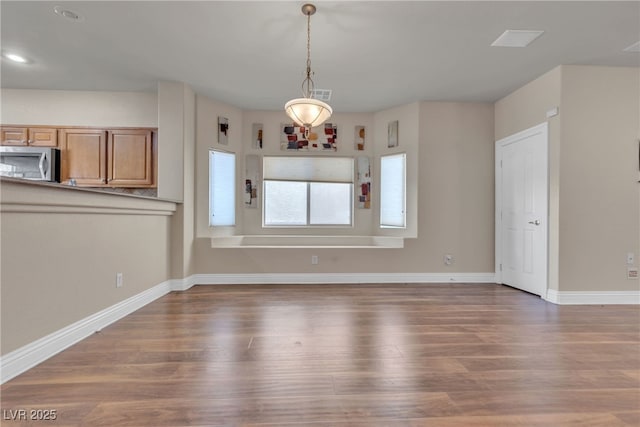 unfurnished dining area with dark hardwood / wood-style flooring