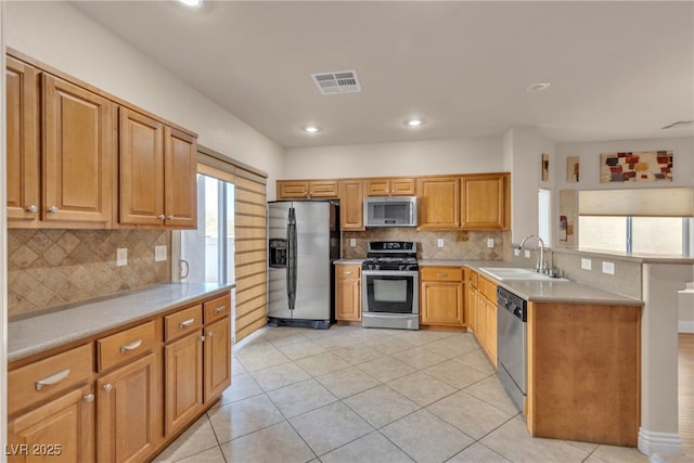 kitchen with tasteful backsplash, sink, light tile patterned floors, and stainless steel appliances