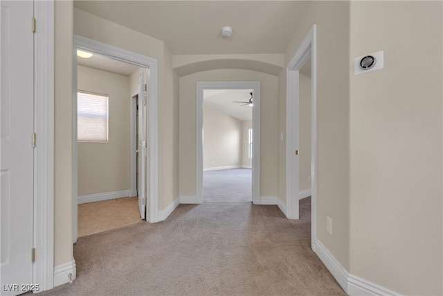 corridor featuring light colored carpet