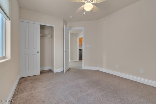 unfurnished bedroom with ceiling fan, a closet, and light carpet