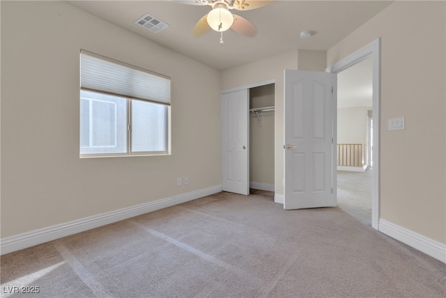 unfurnished bedroom featuring ceiling fan, a closet, and light carpet