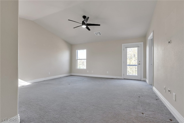 carpeted empty room featuring lofted ceiling and ceiling fan