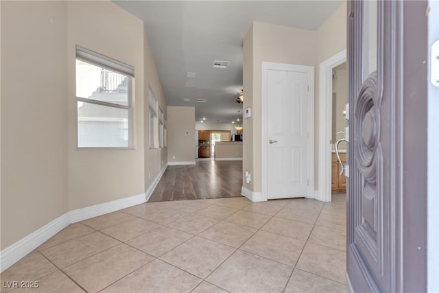 entryway with light tile patterned flooring