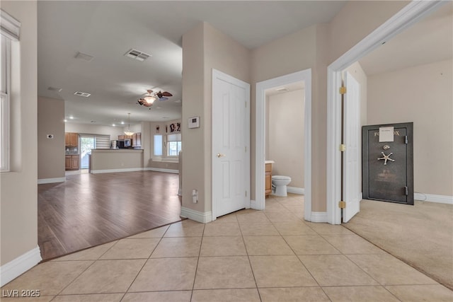 corridor featuring light tile patterned flooring