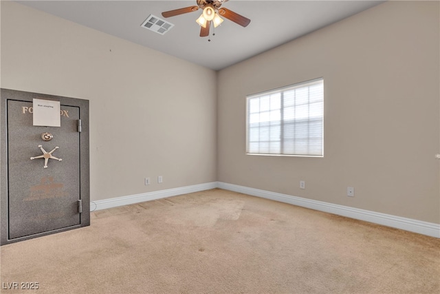 carpeted spare room with ceiling fan