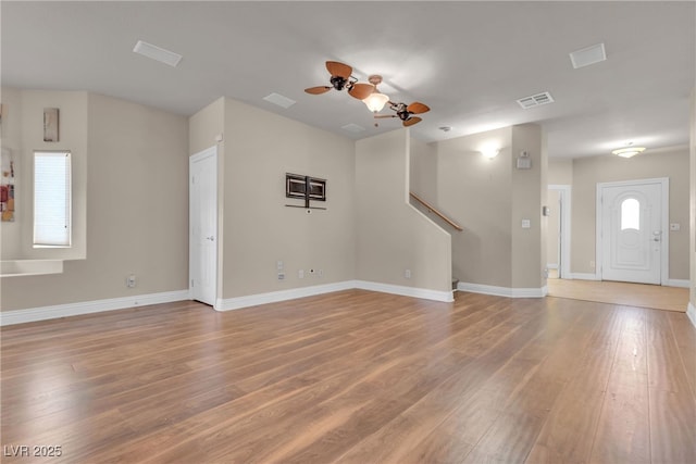 unfurnished living room featuring hardwood / wood-style flooring and ceiling fan