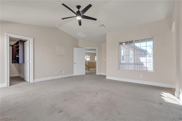 unfurnished living room featuring vaulted ceiling, light carpet, and ceiling fan