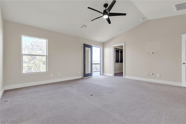 carpeted empty room with ceiling fan and lofted ceiling