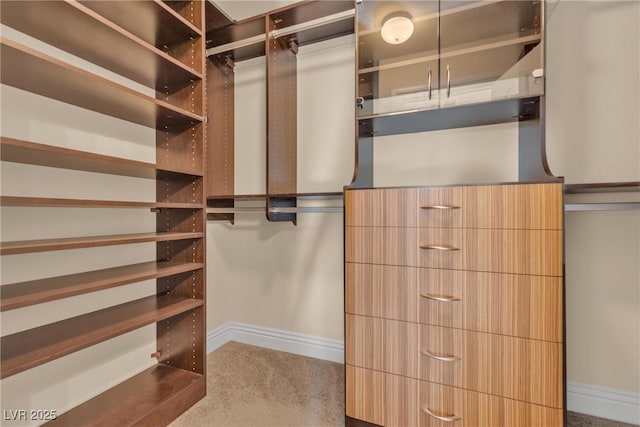 spacious closet featuring dark colored carpet