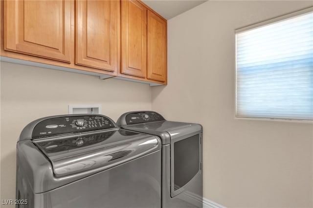 laundry room with cabinets and washing machine and dryer