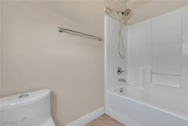 bathroom featuring tile patterned floors, toilet, and bathtub / shower combination