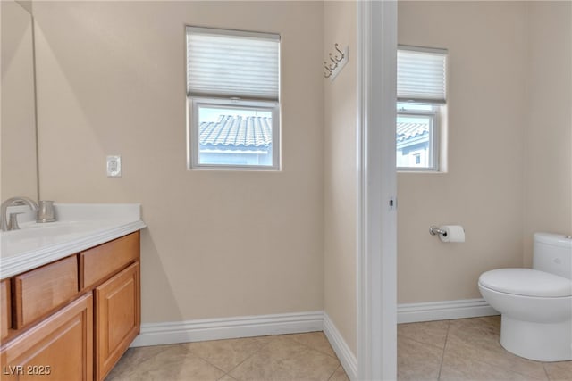 bathroom featuring plenty of natural light, tile patterned floors, and toilet