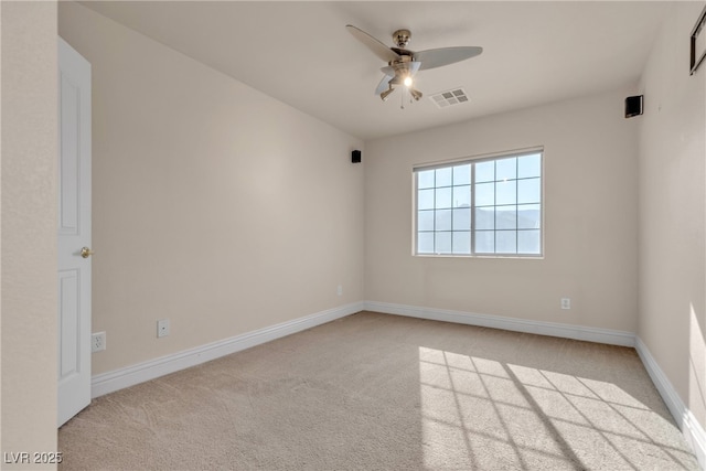 carpeted spare room featuring ceiling fan