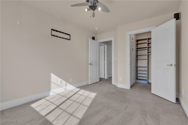 unfurnished bedroom featuring ceiling fan, light colored carpet, and a closet