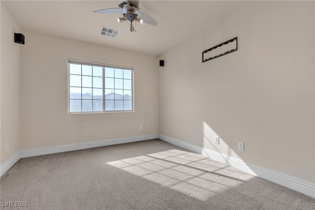 carpeted spare room featuring ceiling fan