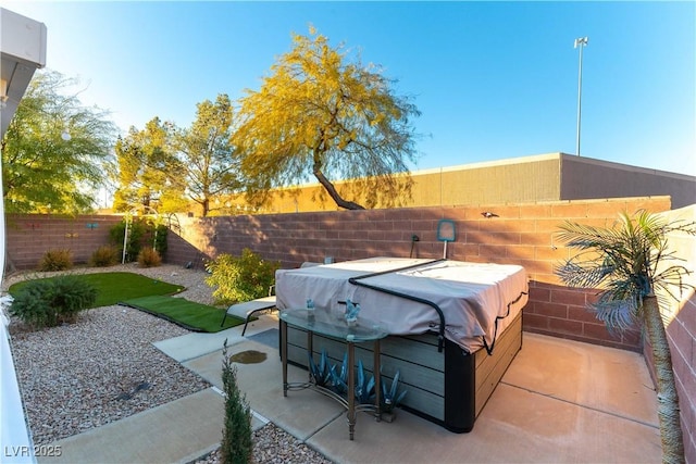 view of patio / terrace with a hot tub