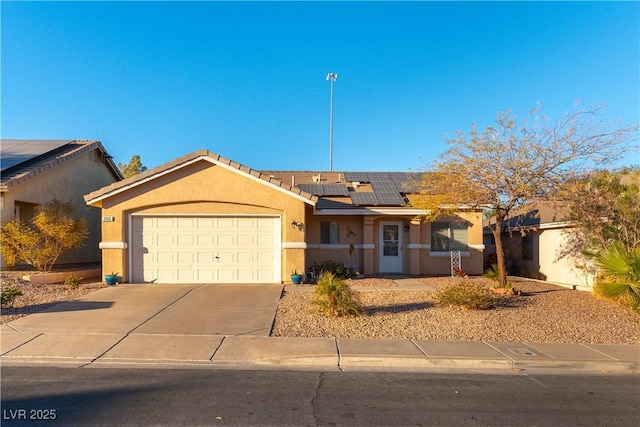 ranch-style house featuring solar panels and a garage