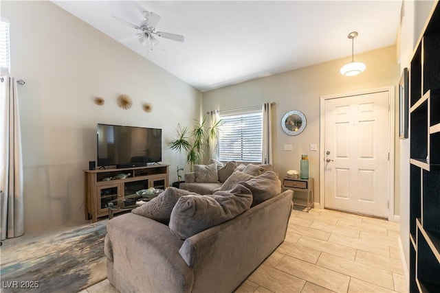 living room featuring vaulted ceiling and ceiling fan