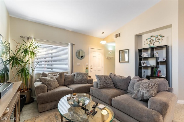 living room featuring lofted ceiling and light tile patterned flooring