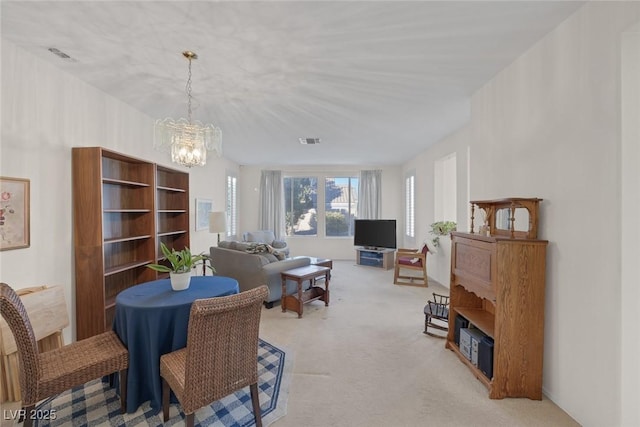 dining room with a notable chandelier and light carpet