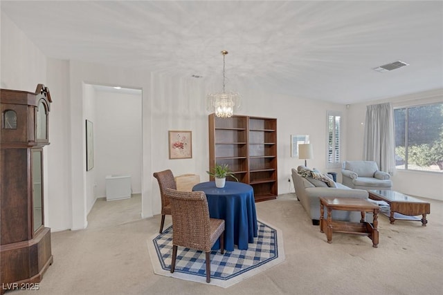 dining area featuring a chandelier and light carpet