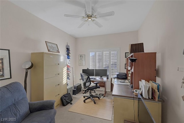 office area with ceiling fan and light carpet