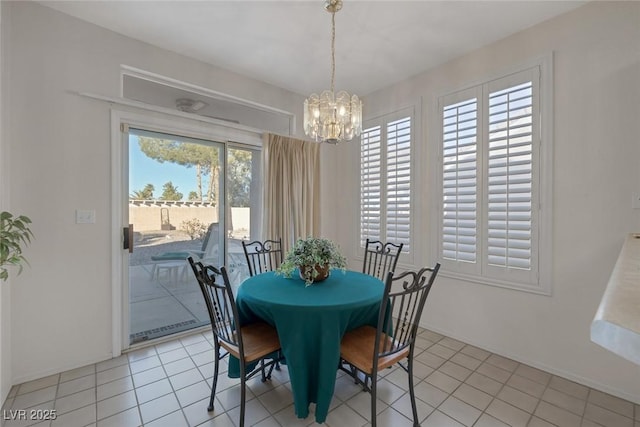 tiled dining space with a wealth of natural light and a notable chandelier