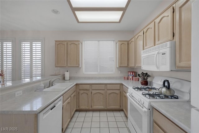 kitchen with kitchen peninsula, white appliances, sink, light brown cabinets, and light tile patterned floors