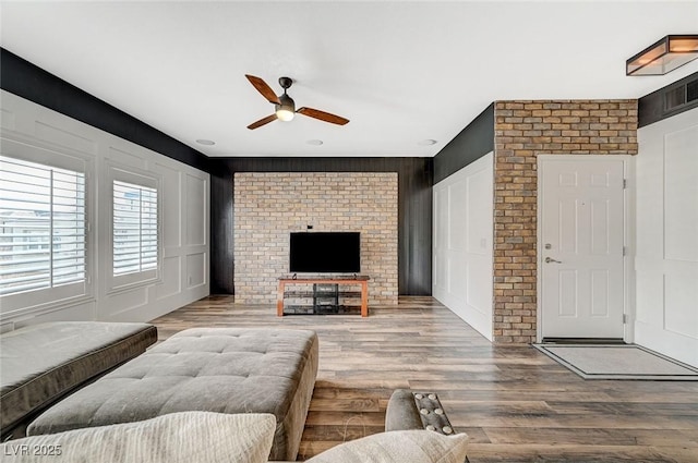 living room with hardwood / wood-style floors and ceiling fan