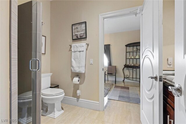 bathroom featuring toilet and an enclosed shower