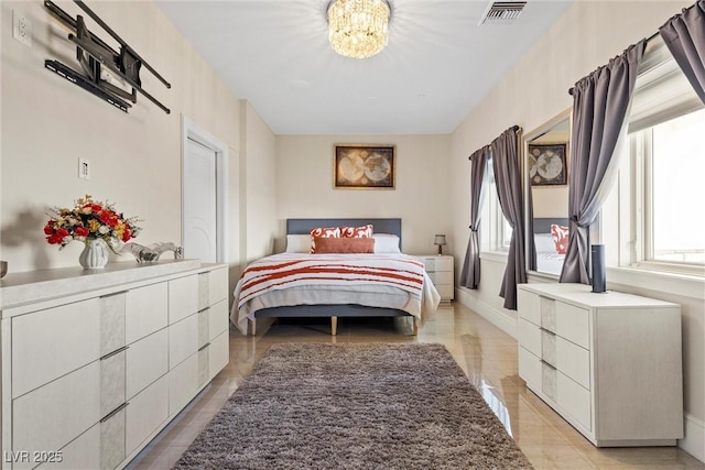 bedroom with a notable chandelier