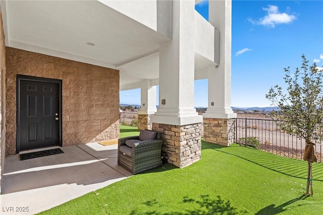 doorway to property featuring a lawn and covered porch