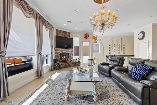 living room with a fireplace, an inviting chandelier, light hardwood / wood-style floors, and ornamental molding