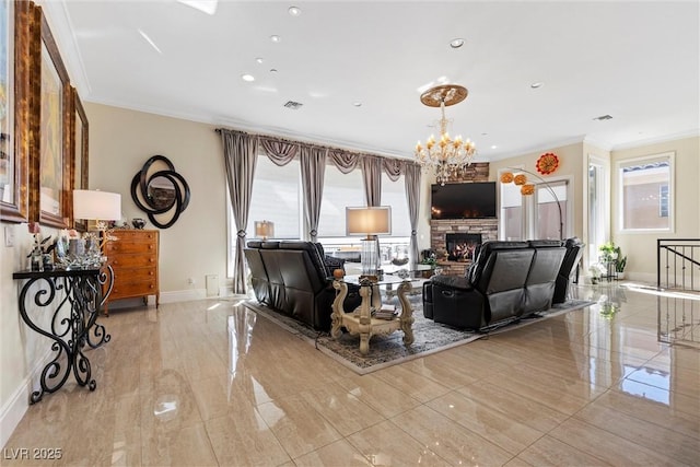 living room with a notable chandelier, crown molding, and a fireplace