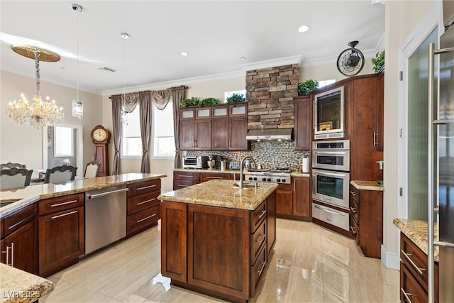 kitchen featuring a center island with sink, hanging light fixtures, ornamental molding, a notable chandelier, and stainless steel appliances