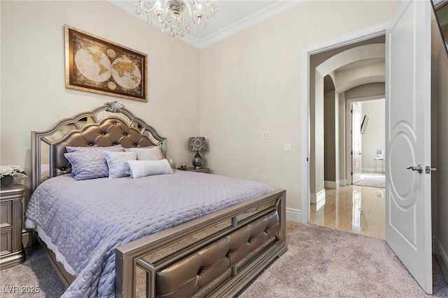 carpeted bedroom with an inviting chandelier and ornamental molding