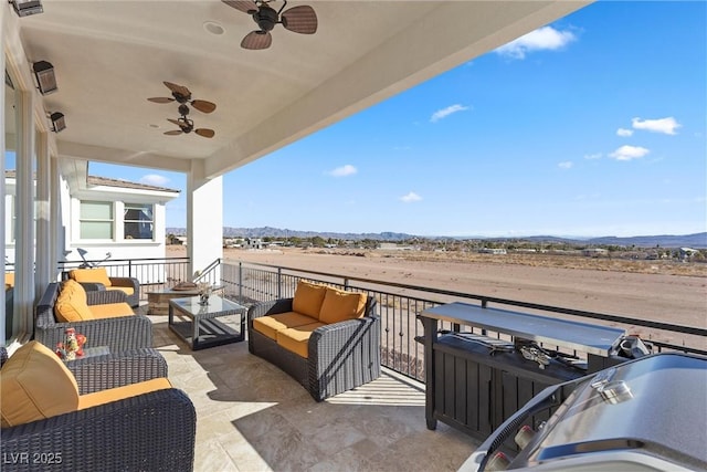 view of patio / terrace featuring an outdoor living space and a mountain view