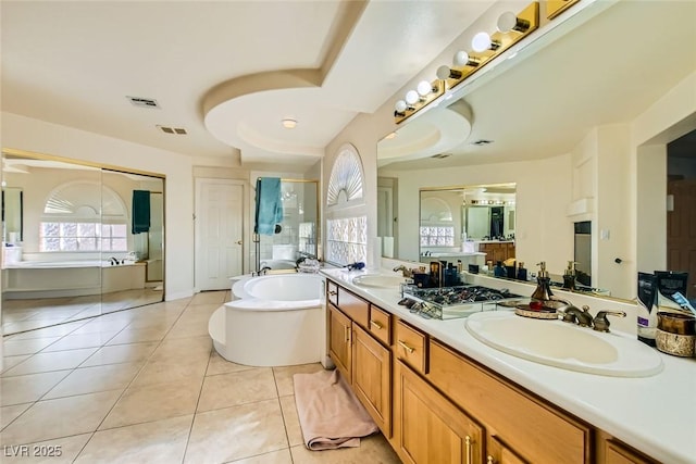 bathroom with tile patterned flooring, shower with separate bathtub, and vanity