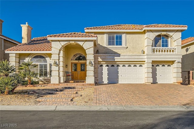 mediterranean / spanish home with a garage