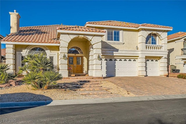 mediterranean / spanish home featuring a garage