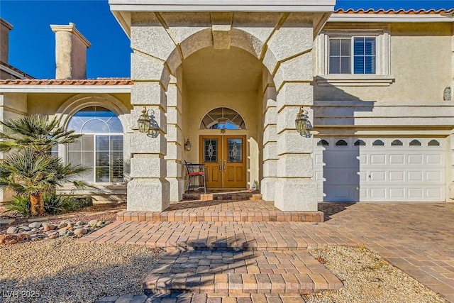 entrance to property with french doors and a garage