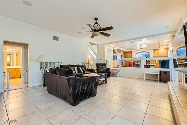 tiled living room with ceiling fan and a healthy amount of sunlight